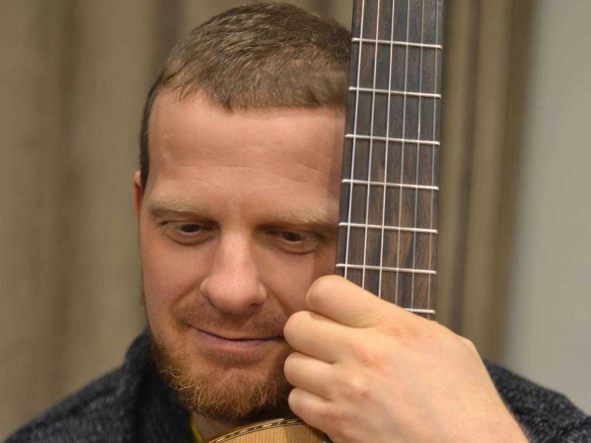 Maksim Cuker holding one of his guitars.