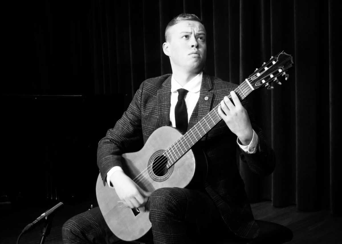 Rick playing the guitar in black and white