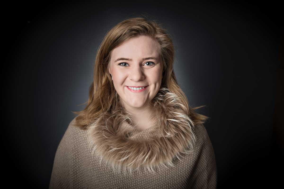 Kristina looking straight at the camera while smiling.
